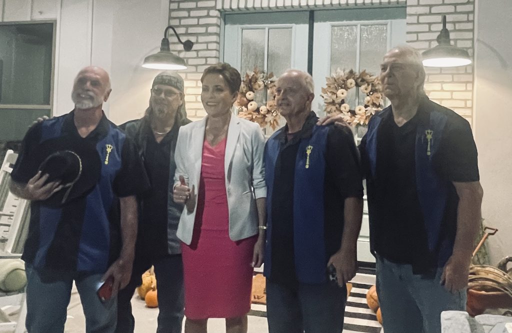 The Right Scepter Band posing for a group photo with Kari Lake during an event in New River, Arizona.